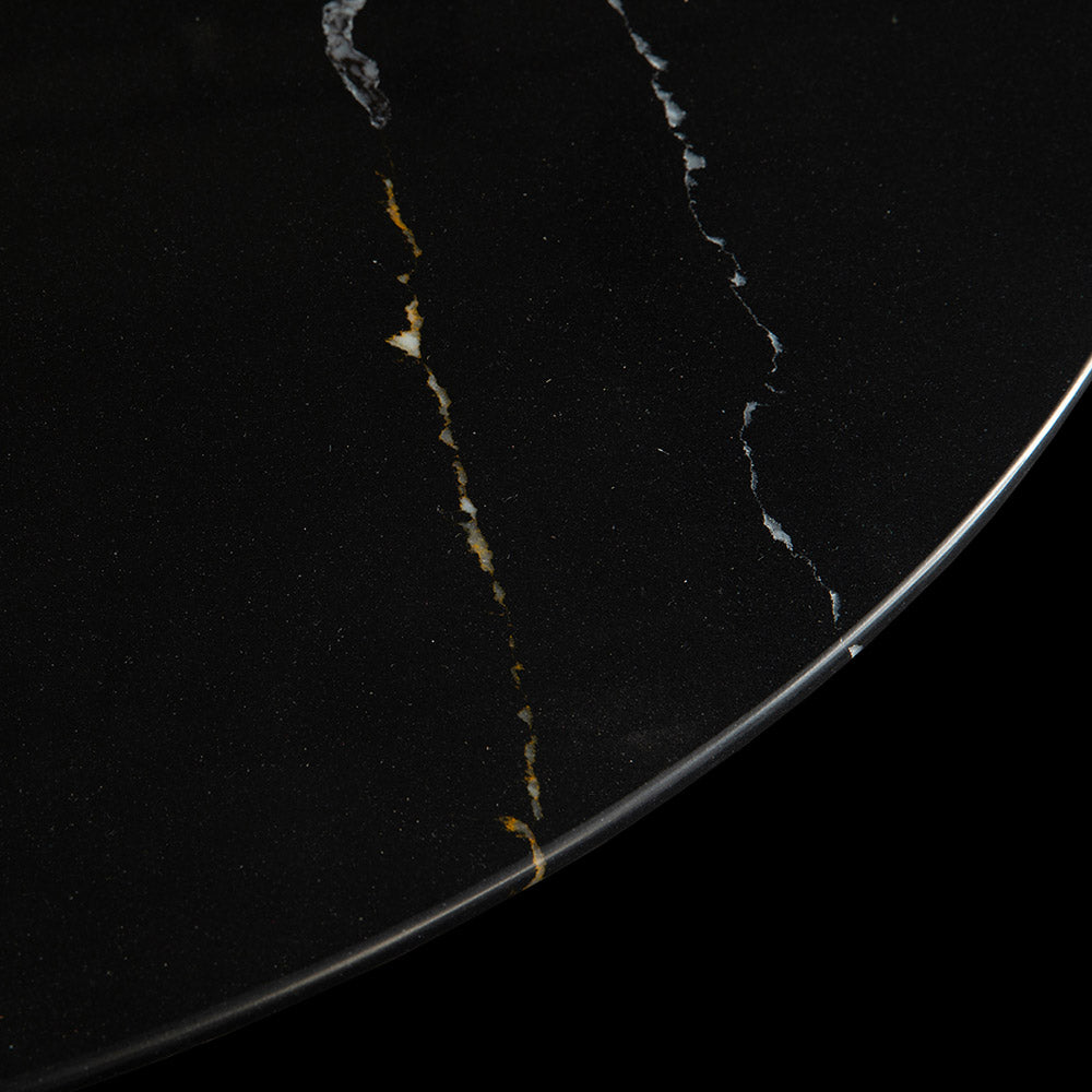 A closer look shows the lightning strike like white and gold veins of the black Nero Marquina marble on this smaller circular Tulip Coffee Table