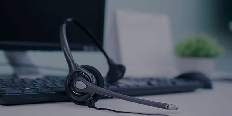 A banner image for the Little Tulip Shop’s contact us page that shows a customer service headset along with a keyboard, come of the ways to get in touch