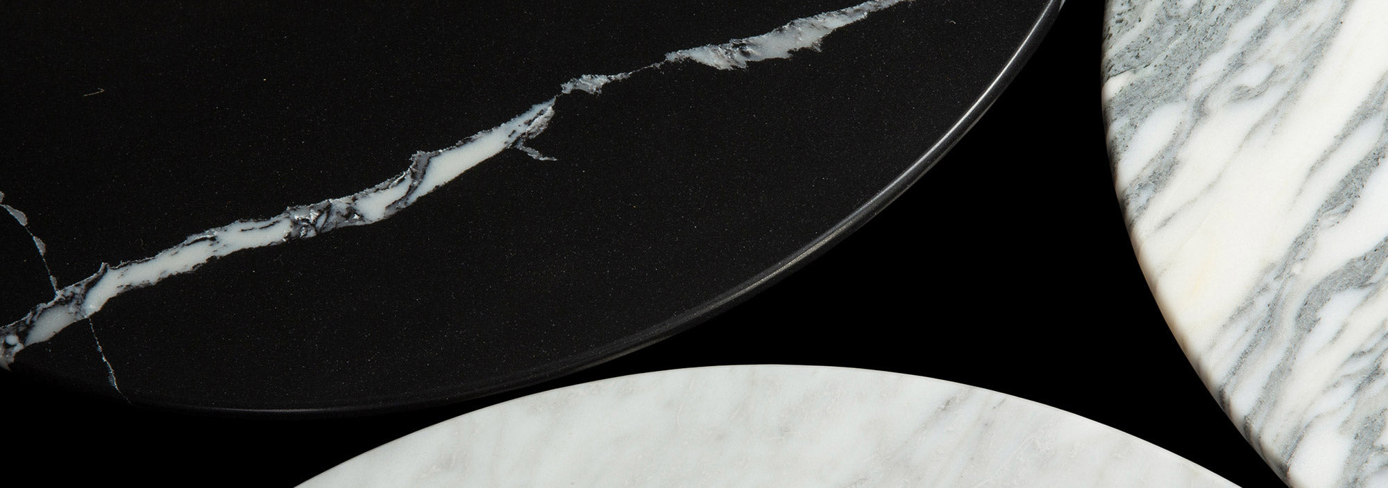 An artistic view of three of the marble finishes available on Little Tulip Shop Tables, the White Carrara, Arabescato and the black Nero Marquina