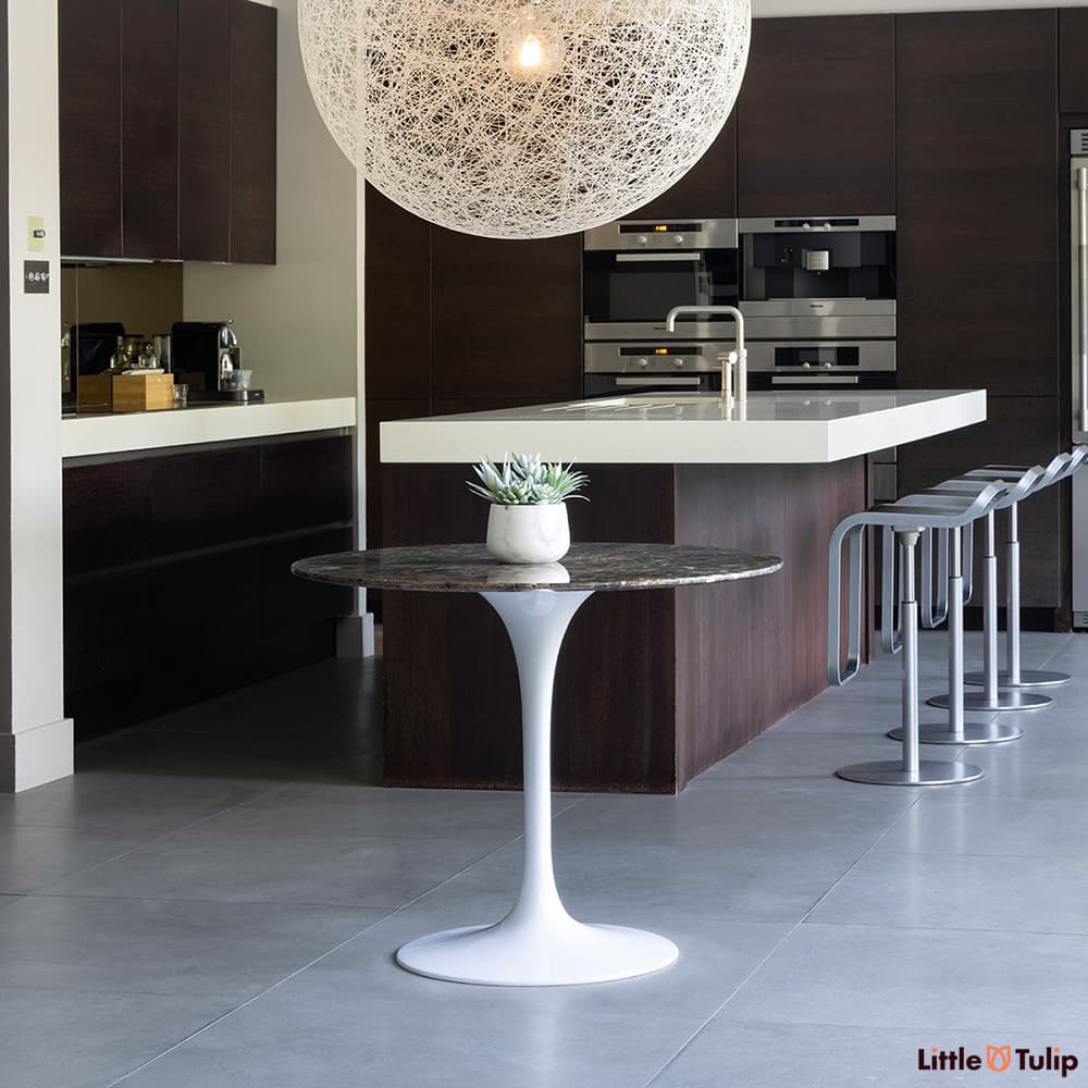 The beautiful collaboration of brown on white is exemplified with this 90 emperador Tulip table and this wonderful kitchen