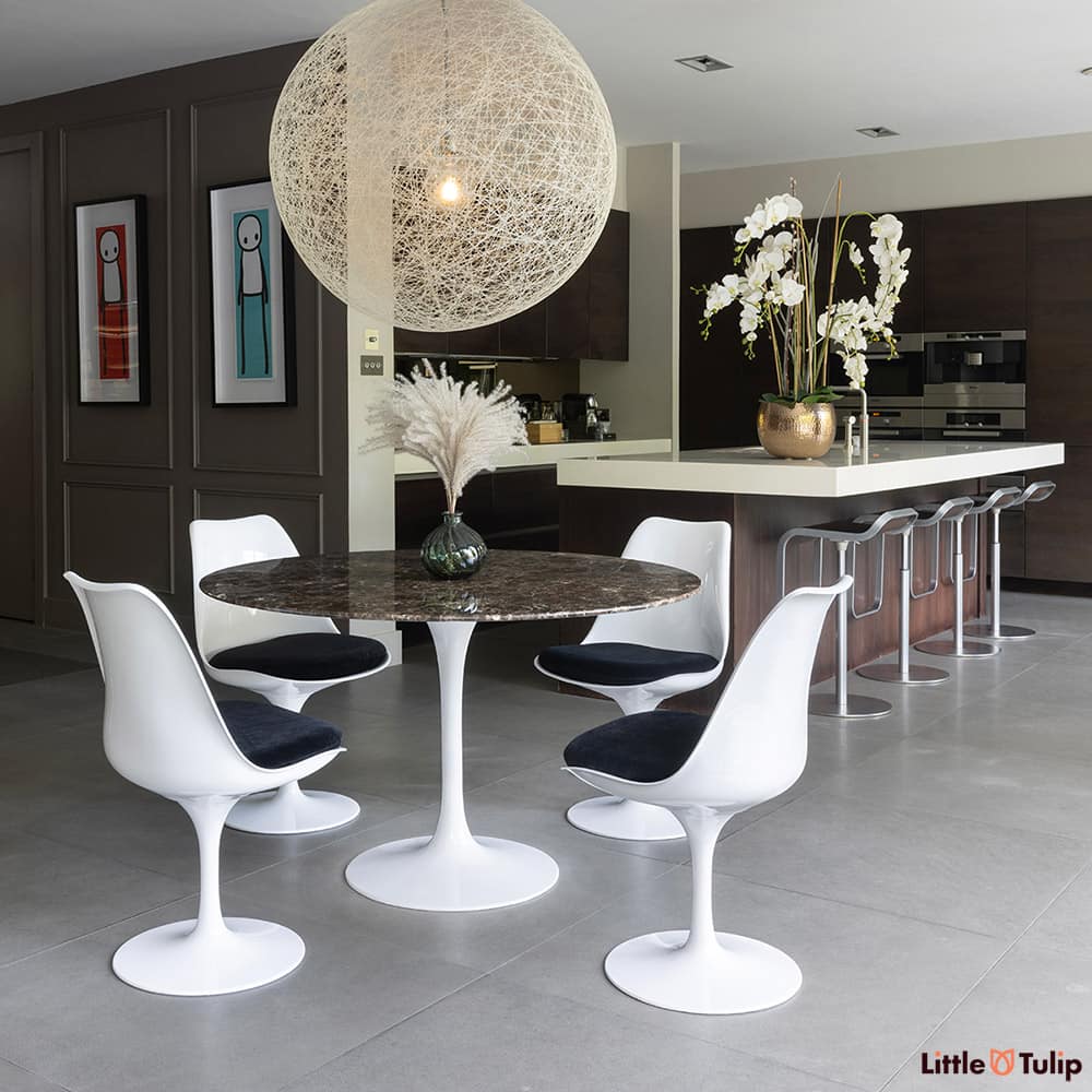 On the edge of the kitchen but still the defining piece is the 120 emperador tulip table with 4 side chairs black cushions