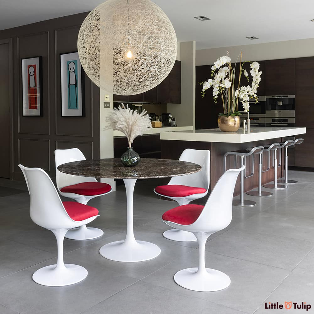 On the edge of the kitchen but still the defining piece is the 120 emperador tulip table with 4 side chairs red cushions