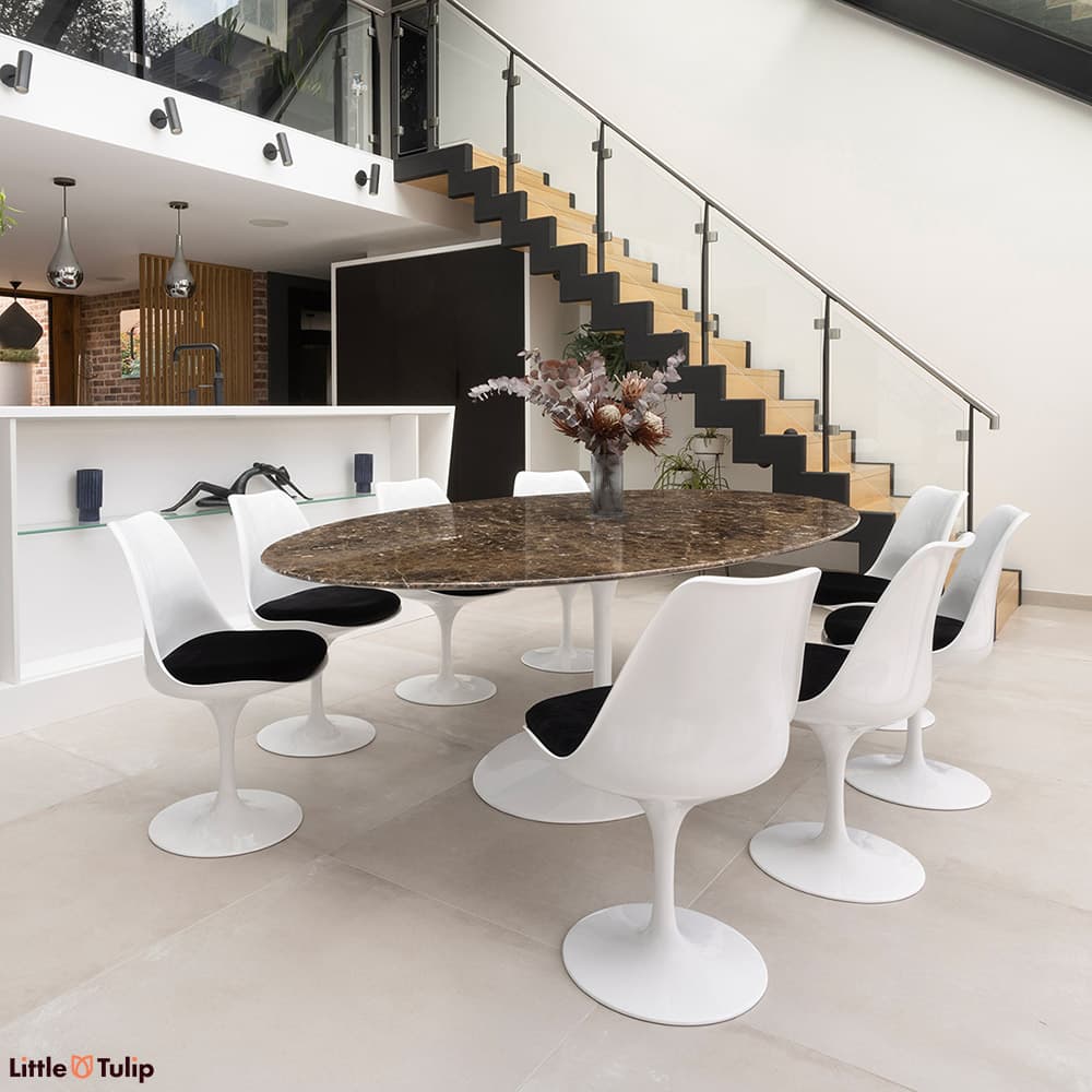 In emperador marble, the 244 tulip table with 8 side chairs and black cushions is a stunning addition to this modern kitchen