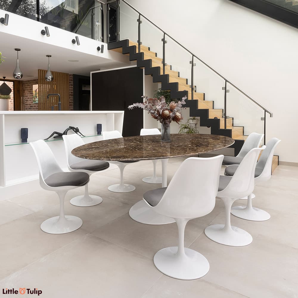 In emperador marble, the 244 tulip table with 8 side chairs and grey cushions is a stunning addition to this modern kitchen