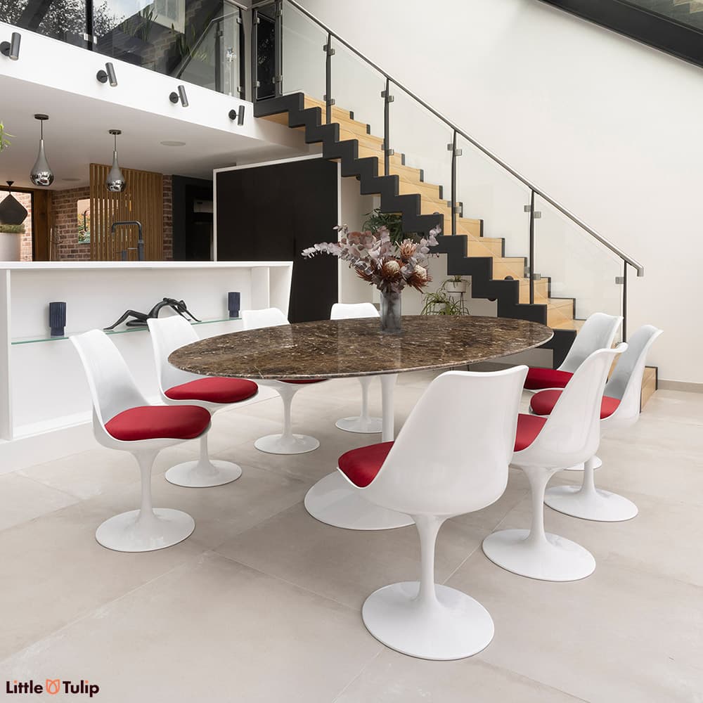 In emperador marble, the 244 tulip table with 8 side chairs and red cushions is a stunning addition to this modern kitchen
