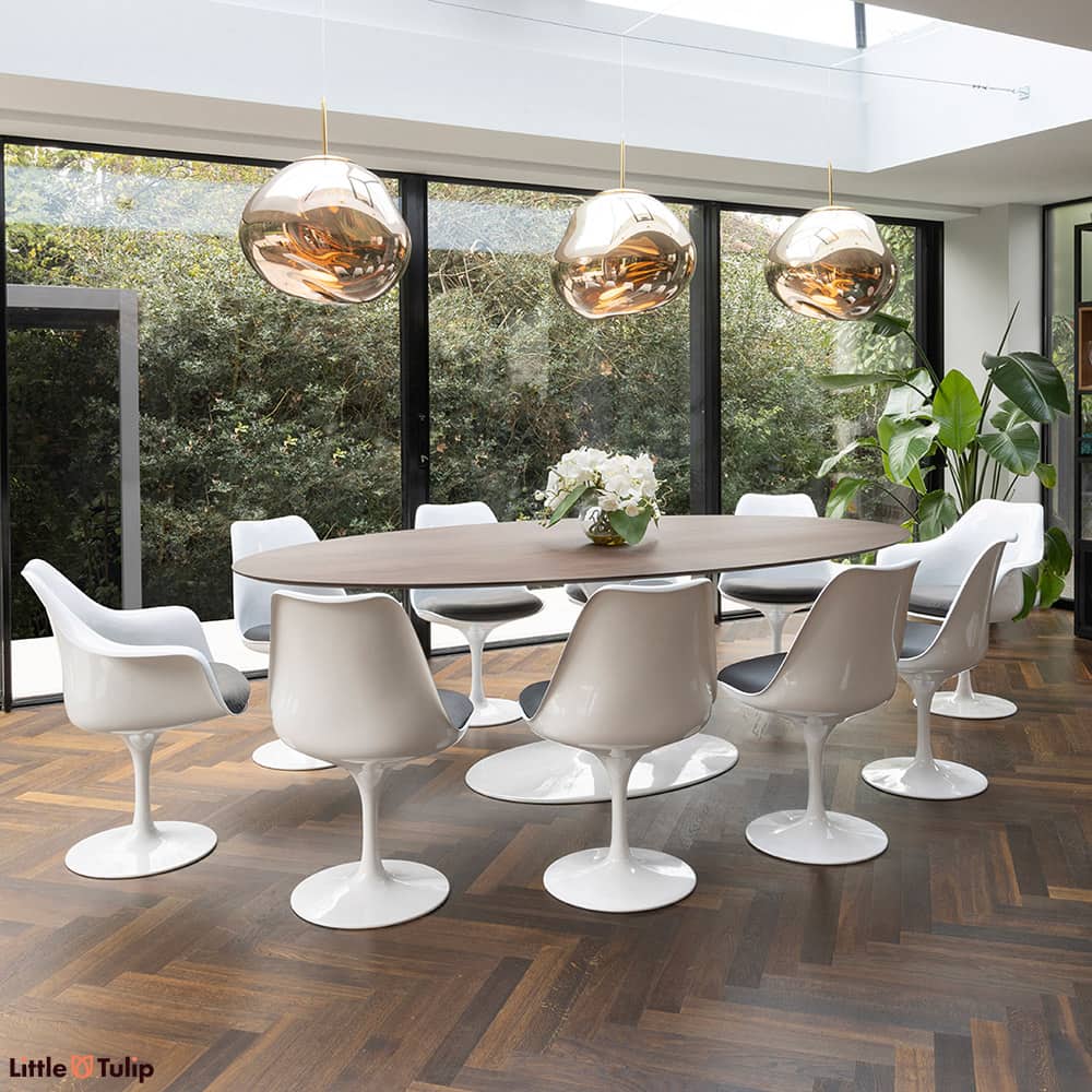 The walnut look elevates the 244 tulip table with 8 side and 2 arm chairs, featuring grey cushions for timeless charm
