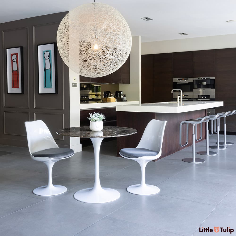 The perfect combination, 2 side chairs with grey cushions around the 90cm emperador tulip table in this fresh kitchen