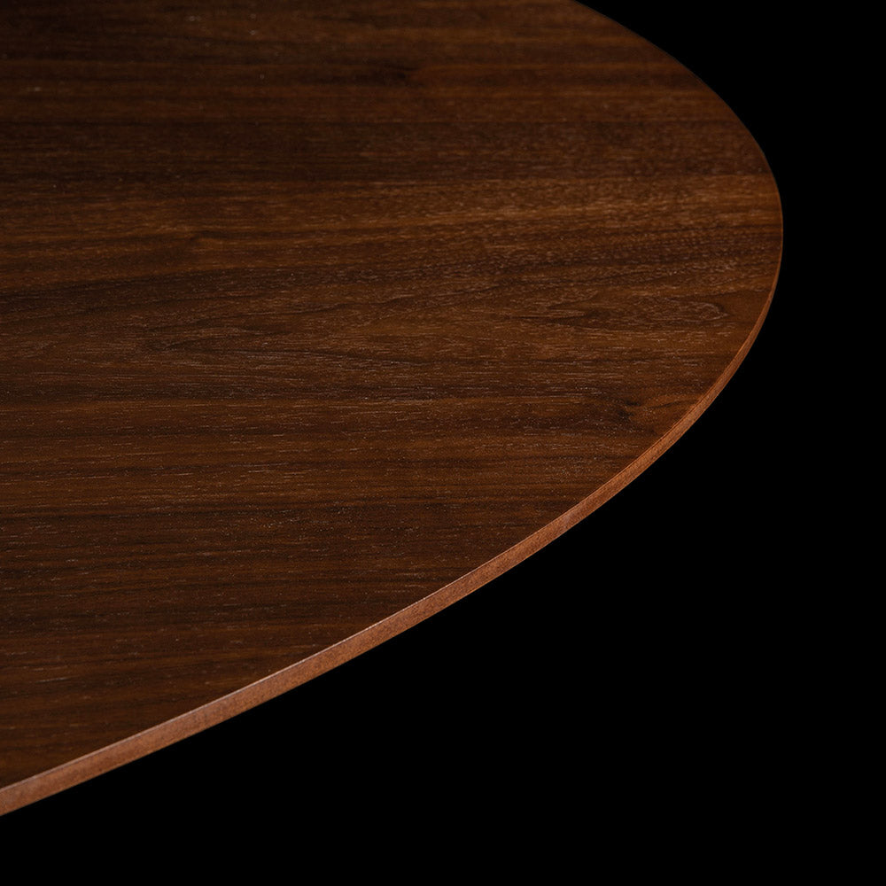 A stunning image that captures the rich tones within the natural Walnut Veneer Tulip table top against the dark silhouette of a black background