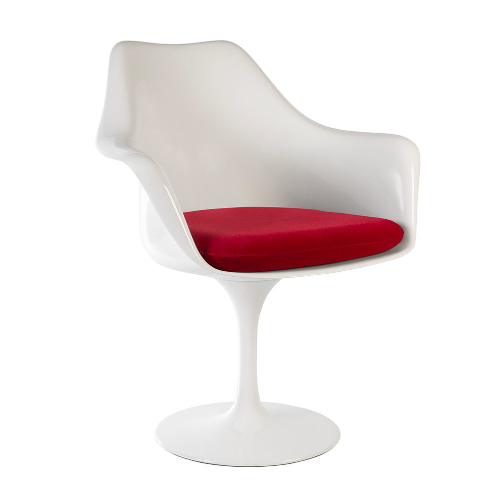 A Saarinen Tulip Arm Chair in a super high quality fibreglass seen simply at a three quarter angle, proudly displaying its vibrant alluring red seat cushion