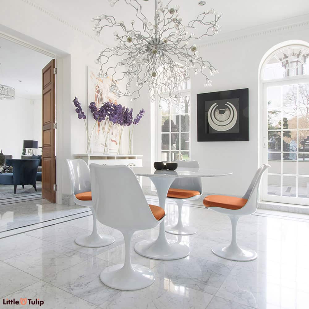 Make the ultimate statement with a table made with pure Carrara Marble, seen here on a 120cm Tulip Table and 4 matching Tulip Chairs with Orange cushions