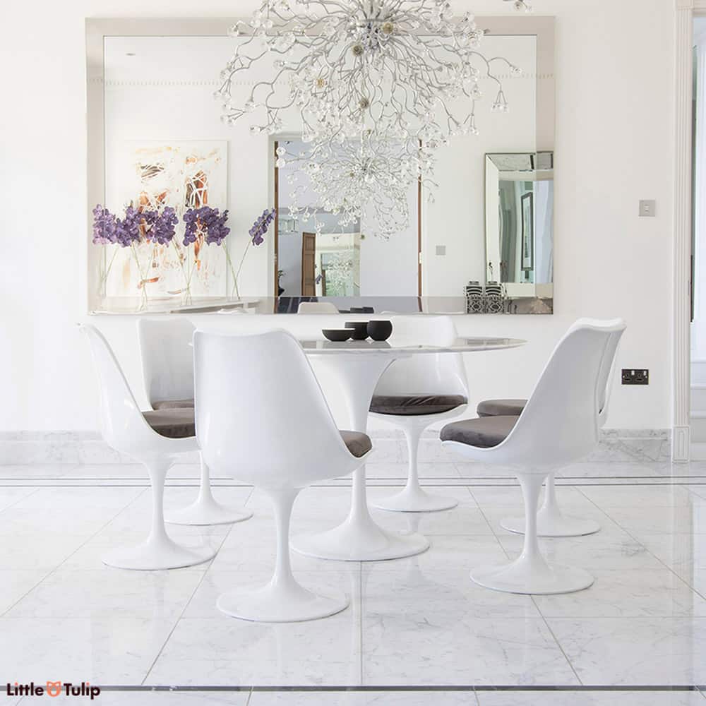 A truly classic set, the largest 120 cm circular Carrara Marble Tulip Table flanked by six wonderful matching Tulip Side chairs with grey cushions