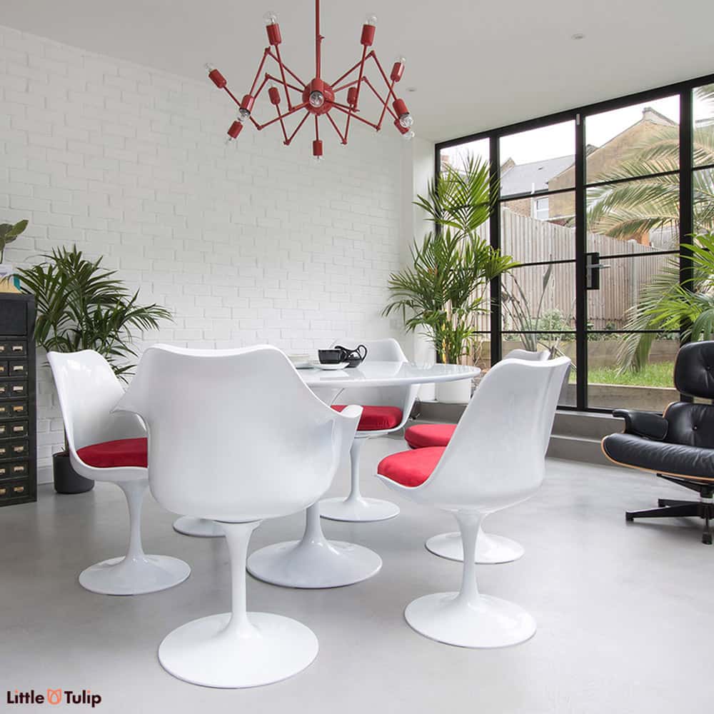 Keep things light with a beautiful clean cut 120 cm White laminate Tulip dining table with 6 matching Tulip side & arm chairs finished with red cushions