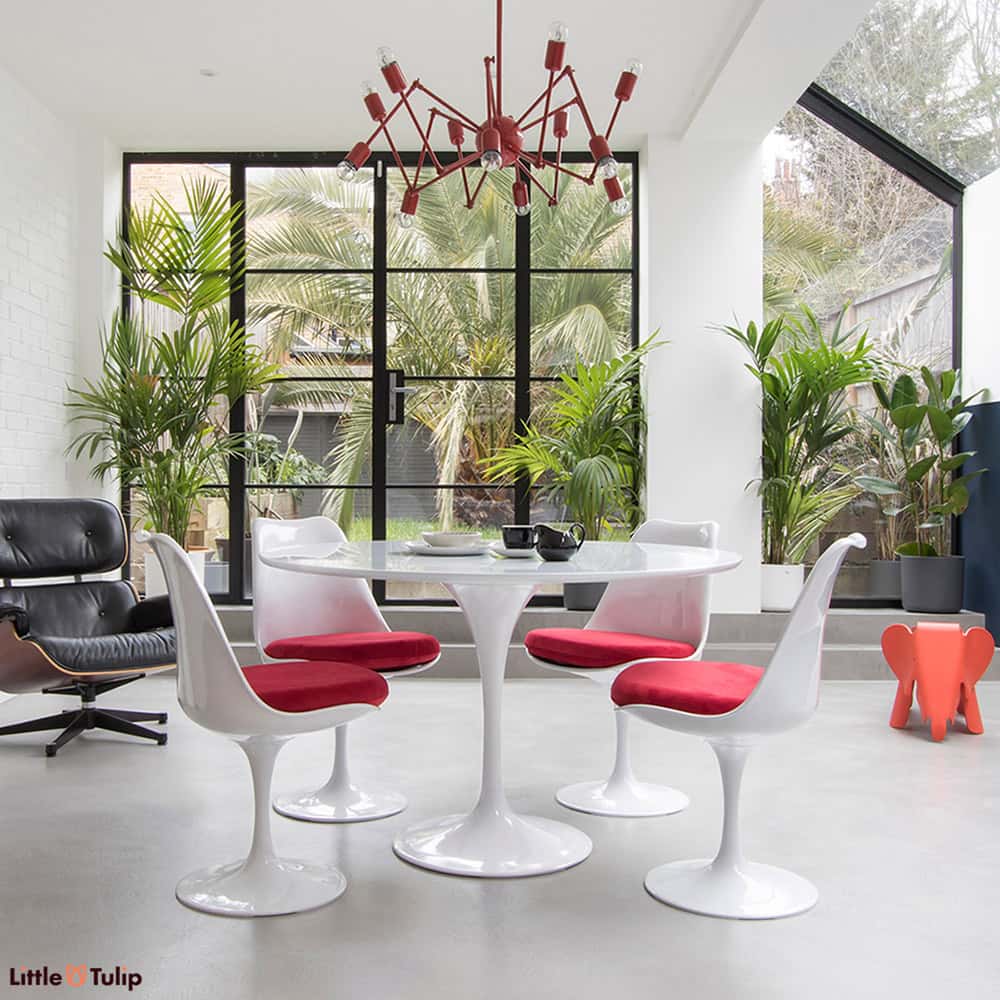 The beautiful sheer white sheen of the original classic 120 cm Tulip Table is perfect with a group of 4 Tulip Side Chairs with soft velvety red cushions