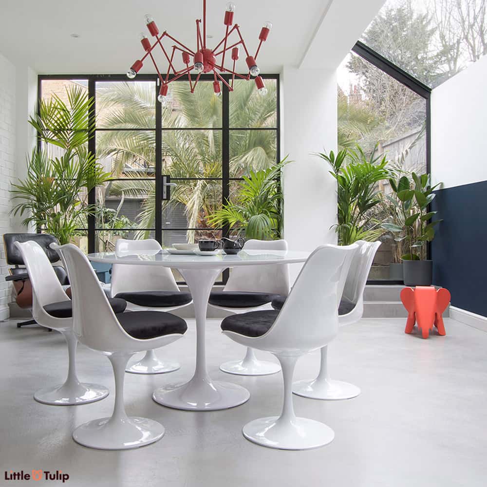 Simplicity personified with the Classic White Saarinen Tulip Table 120 cm matched together with the Tulip Side Chairs & finished with soft black cushions