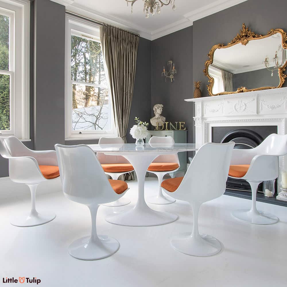 Quintessential Tulip dining is seen here with a 170 x 110 cm oval Carrara marble table, 4 side & 2 carver arm Tulip chairs finished in a soft orange velvet