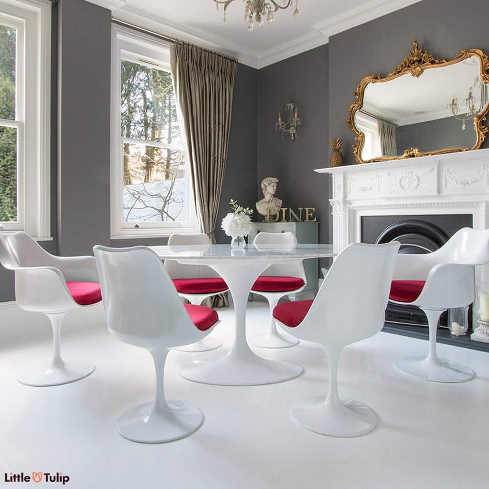 Quintessential Tulip dining is seen here with a 170 x 110 cm oval Carrara marble table, 4 side & 2 carver arm Tulip chairs finished in a soft red velvet