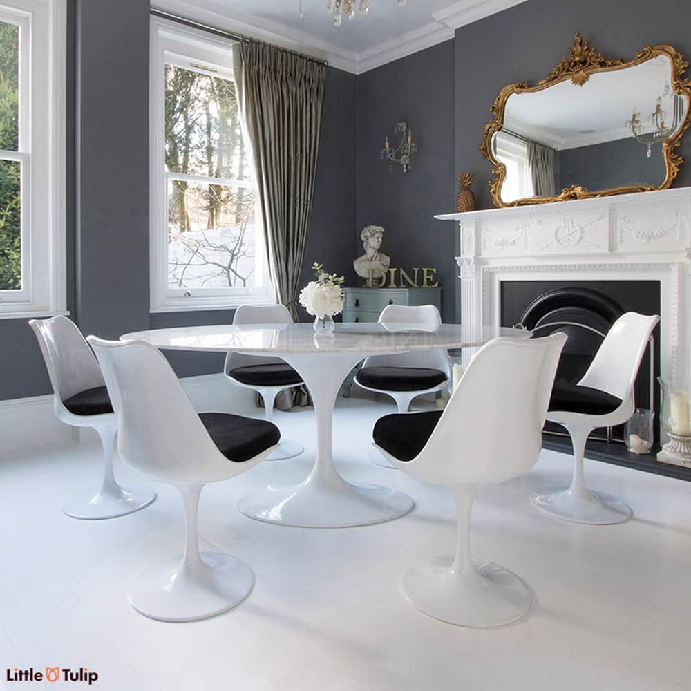 Homely tones radiate from this super cool 170 cm White Carrara Marble Tulip Table paired together with six of the matching side chairs with black cushions