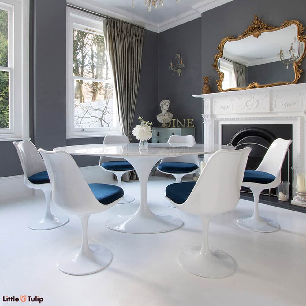 Homely tones radiate from this super cool 170 cm White Carrara Marble Tulip Table paired together with six of the matching side chairs with blue cushions