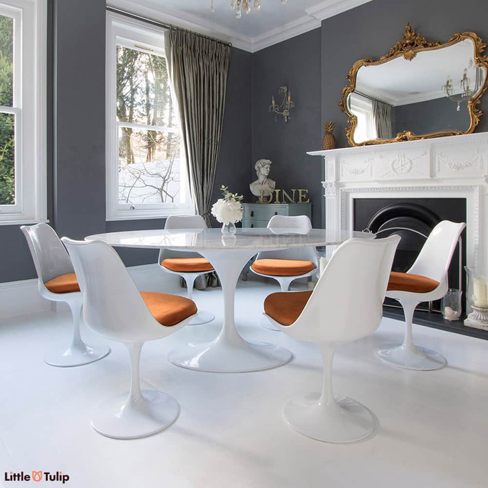 Homely tones radiate from this super cool 170 cm White Carrara Marble Tulip Table paired together with six of the matching side chairs with orange cushions