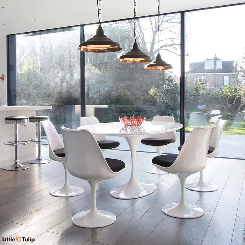A 170 cm Oval Tulip Table in the classic white gives a room more light, more visual space & coupled with 6 Tulip chairs in black fabric, real theatre too