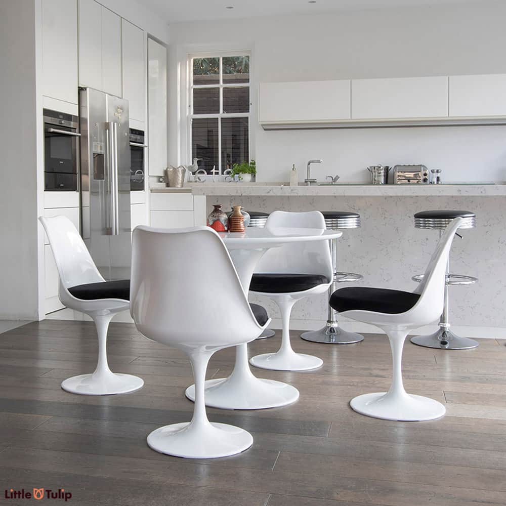 A super clean cut look is achieved in this light spacy kitchen by the 90cm classic White Tulip Table & four matching side chairs with deep black cushions