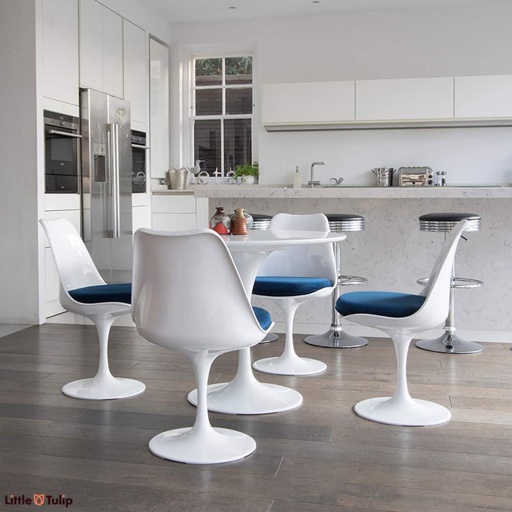 A super clean cut look is achieved in this light spacy kitchen by the 90cm classic White Tulip Table & four matching side chairs with cooling blue cushions