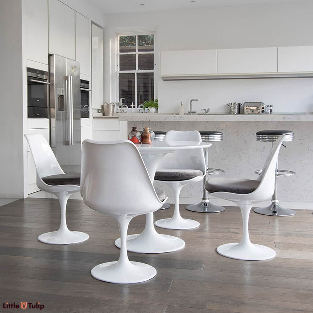 A super clean cut look is achieved in this light spacy kitchen by the 90cm classic White Tulip Table & four matching side chairs with velvet grey cushions