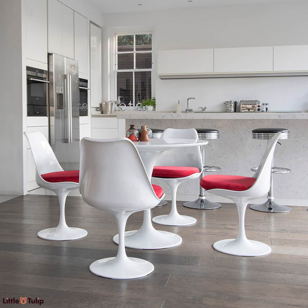A super clean cut look is achieved in this light spacy kitchen by the 90cm classic White Tulip Table & four matching side chairs with gorgeous red cushions