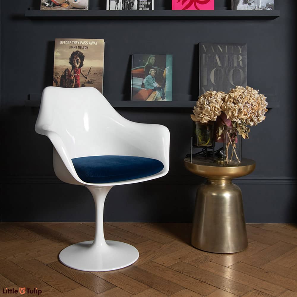 A chair as timeless as a design can be, a Saarinen Tulip Arm Chair, here with a blue velveteen cushion, is the essence of design that simply never ages