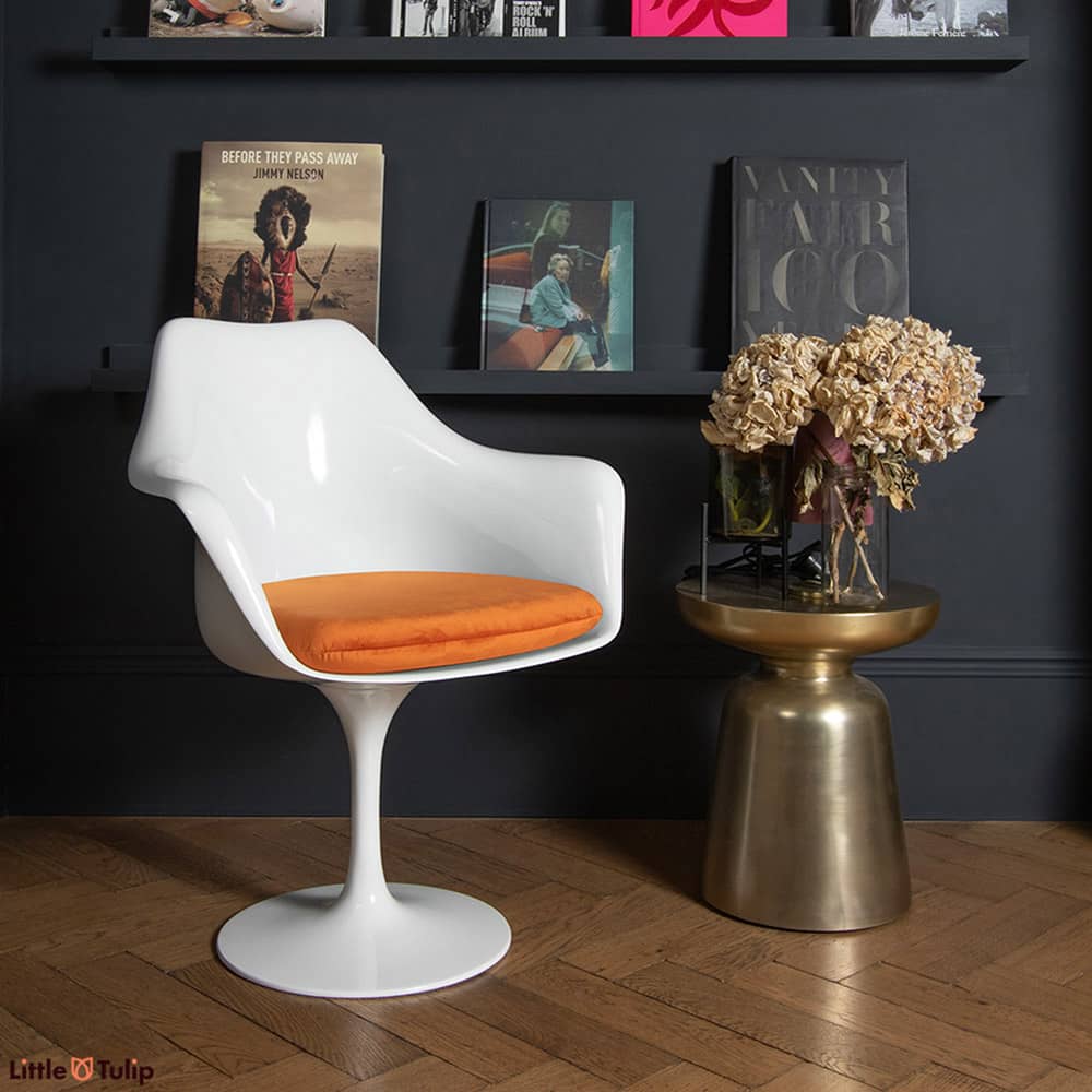 A chair as timeless as a design can be, a Saarinen Tulip Arm Chair, here with a orange velveteen cushion, is the essence of design that simply never ages