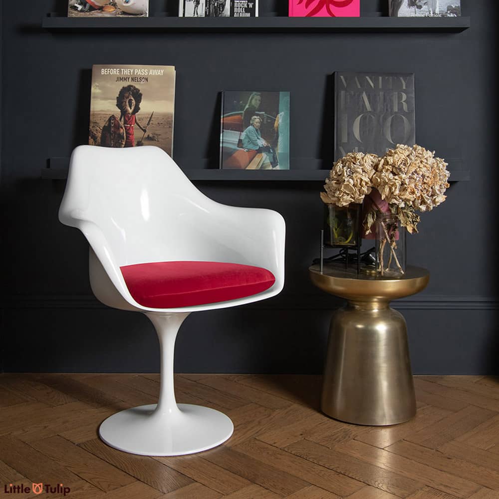 A chair as timeless as a design can be, a Saarinen Tulip Arm Chair, here with a red velveteen cushion, is the essence of design that simply never ages