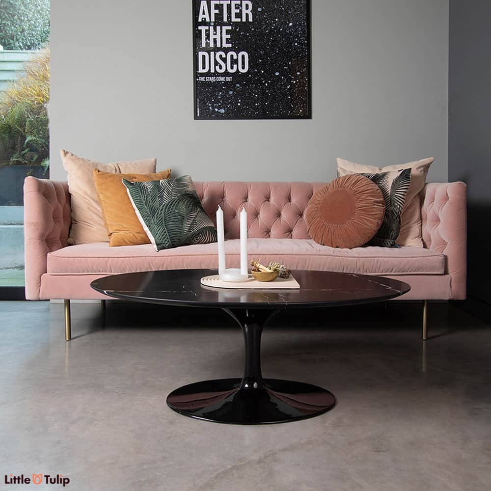 A wonderful black Nero Marquina Saarinen Tulip Coffee Table stands proudly against a pale pink sofa, the perfect finishing touch to this living room