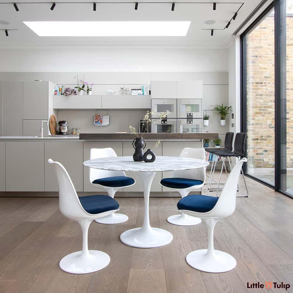 A beautifully finished modern kitchen finished in spectacular style with a 120 cm Tulip Table in Arabescato Marble & 4 side chairs with deep blue cushions