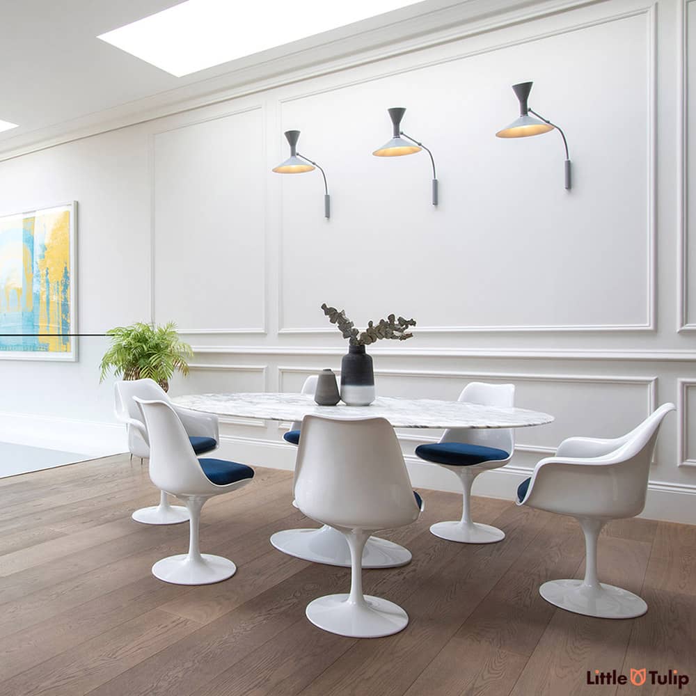 An absolutely gorgeous combination of white space and wooden floor is home to an Arabescato 200 cm Oval table with 4 side & 2 arm chairs with blue cushions
