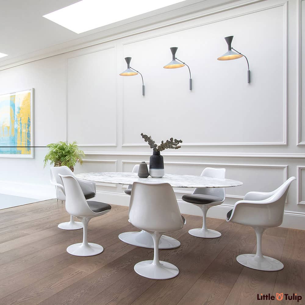 An absolutely gorgeous combination of white space and wooden floor is home to an Arabescato 200 cm Oval table with 4 side & 2 arm chairs with grey cushions