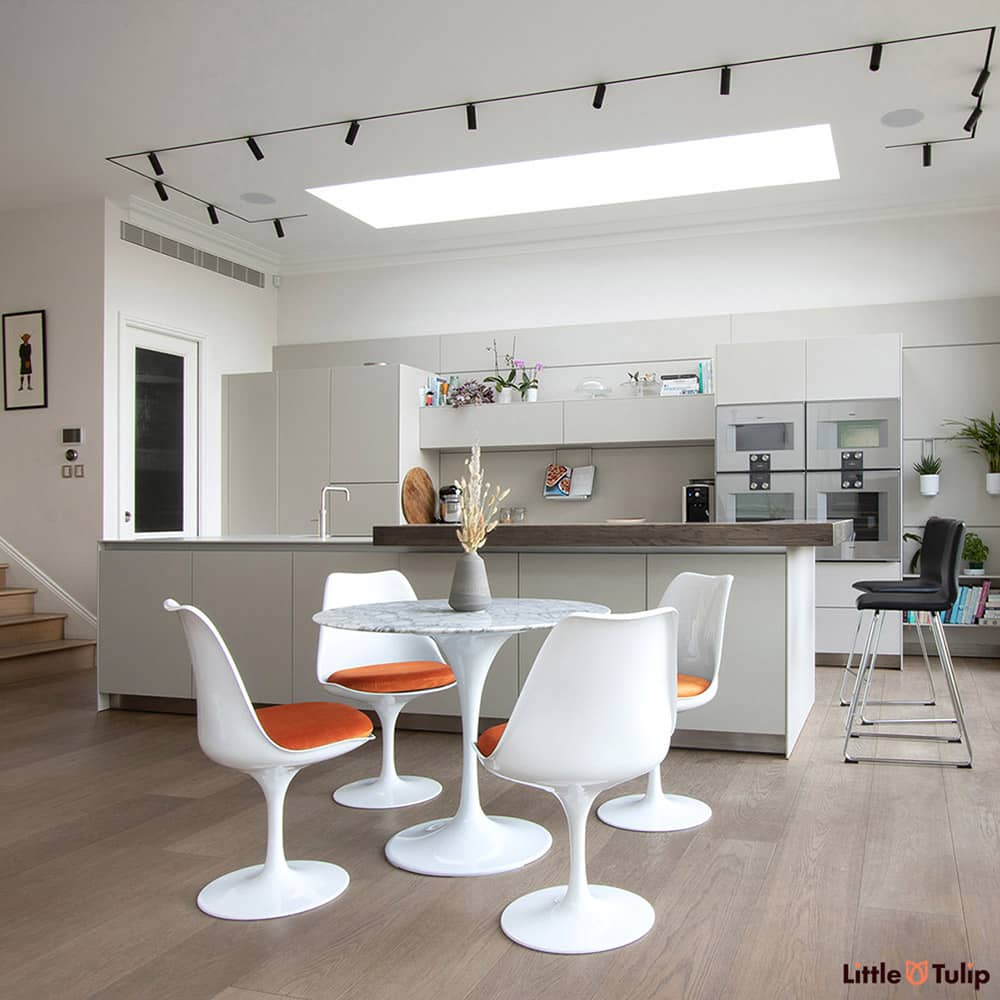 Is this the perfect kitchen? It could well be, the Arabescato 90 cm Tulip Table & side chairs with dazzling orange cushions are simply divine in this space