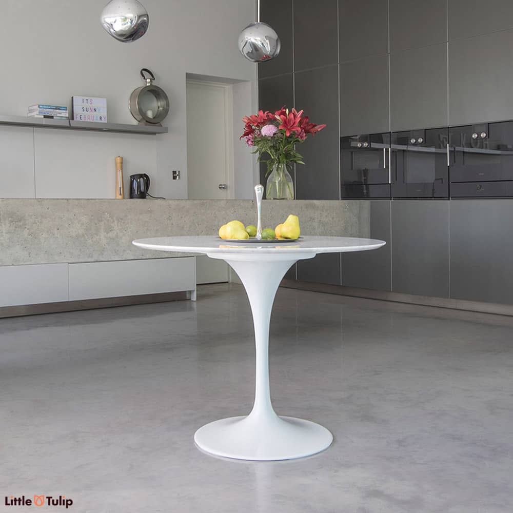 The 90 cm small round Tulip table seen here in the wonderful white and subtle grey Carrara Marble is perfect for small dining and kitchen spaces